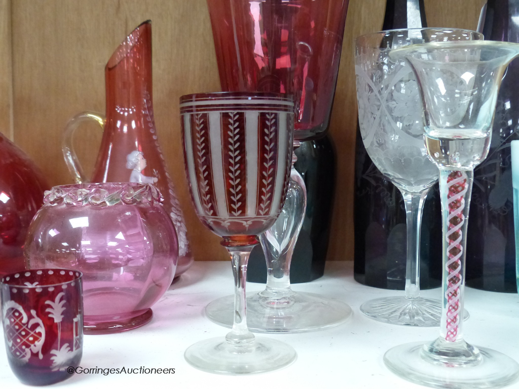 A pair of amethyst glass decanters, cranberry glass and mixed 19th and 20th century coloured glassware